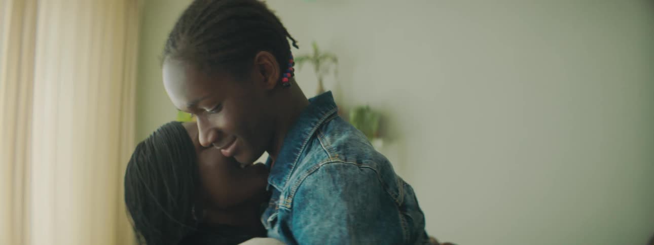 Mother hugging her son at home in a living room