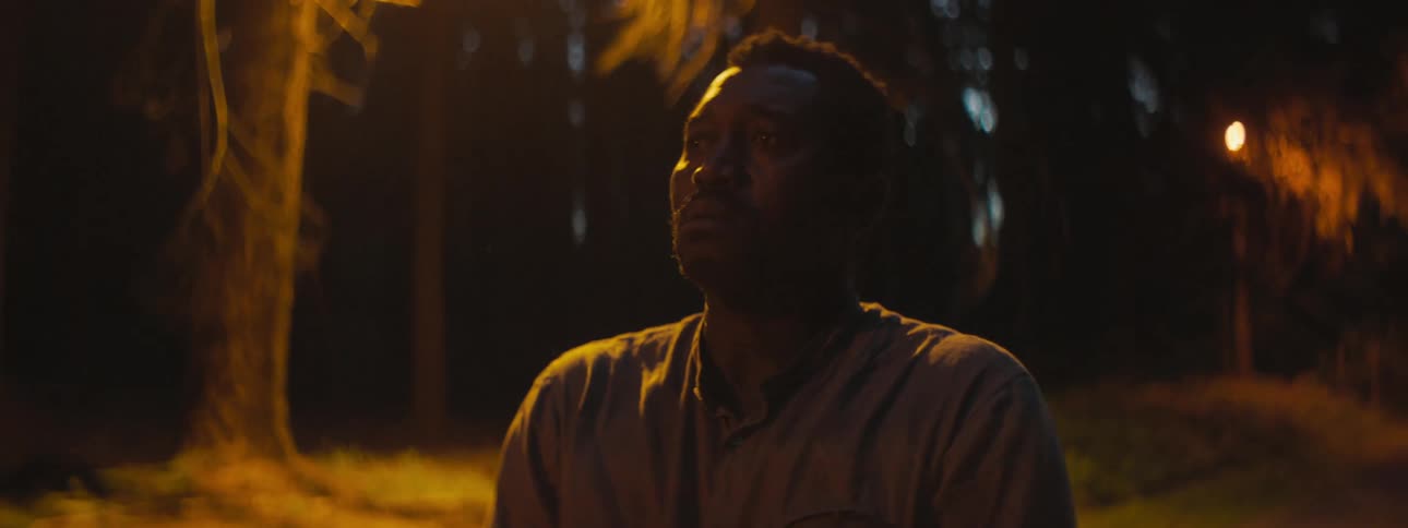 Depressed and sad man with a shirt stands in the middle of the road looks around in the forest