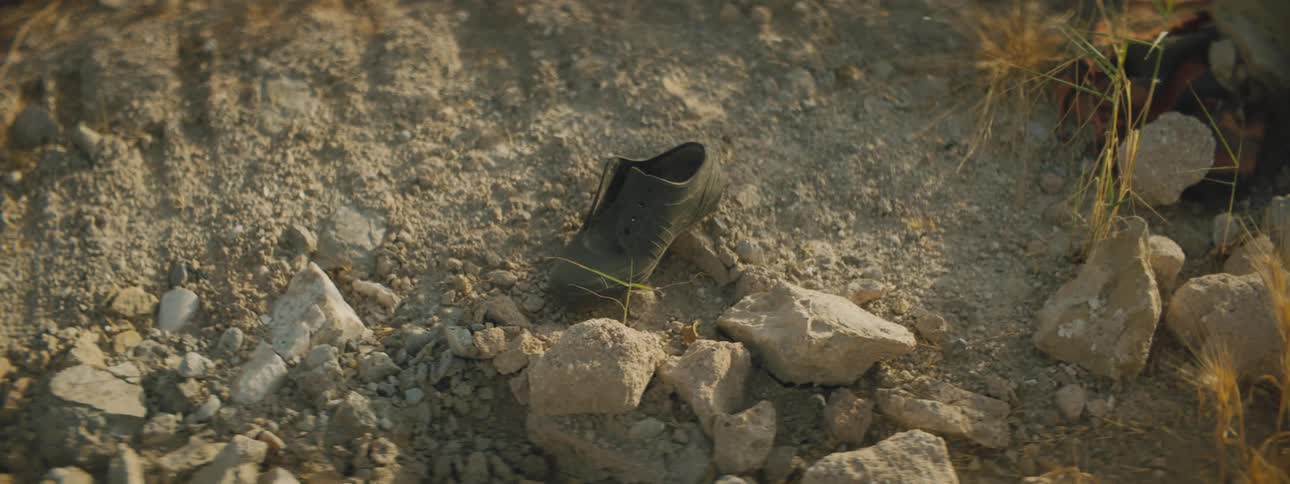 Abandoned shoe in between some rocks