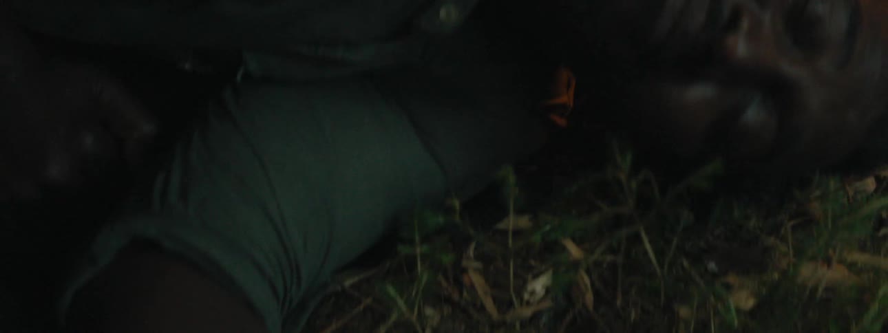 Man laying down in grass with his eyes closed