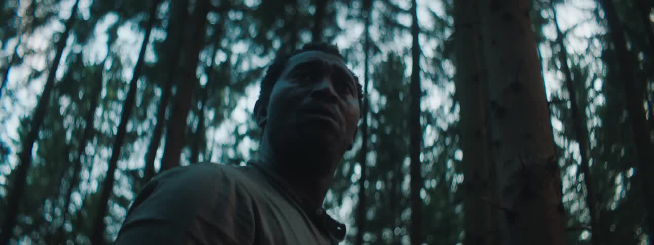 Depressed and sad man looks around in the woods