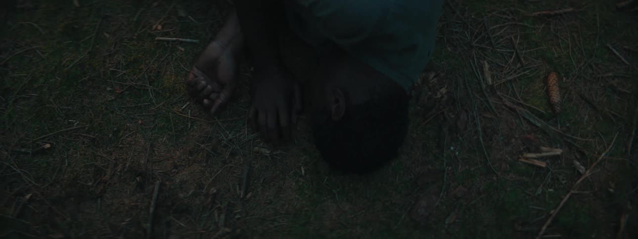 An injured man lays on the ground