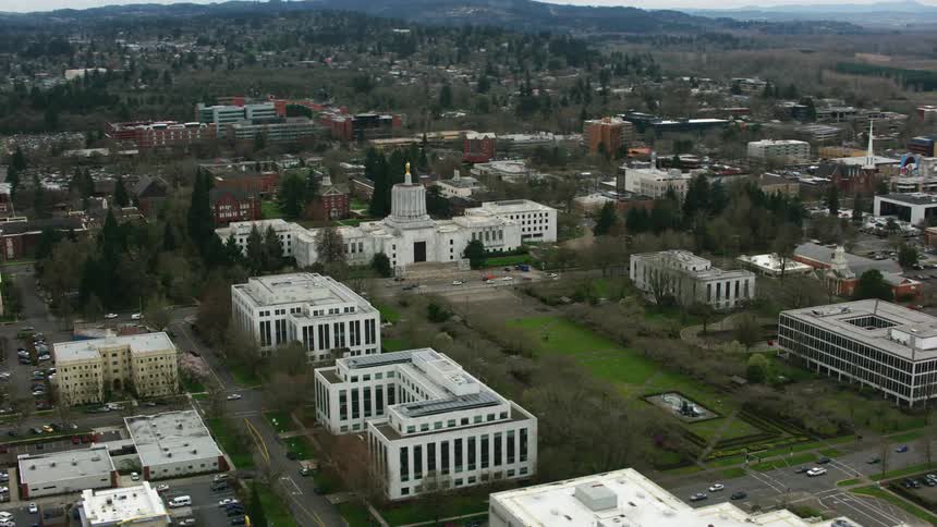 An aerial view of cars driving past office buildings in a city