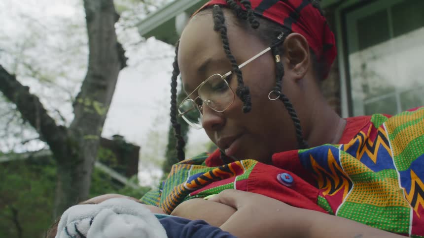 A woman is breastfeeding her baby