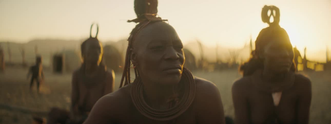 Members of a tribe sitting outside