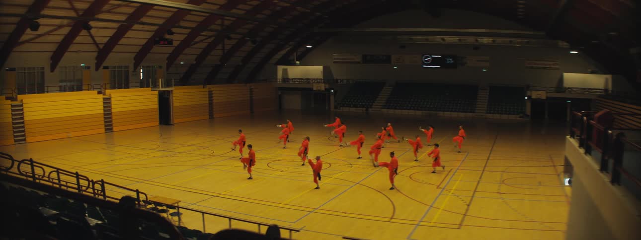 A group of men performing martial arts in a gymnasium