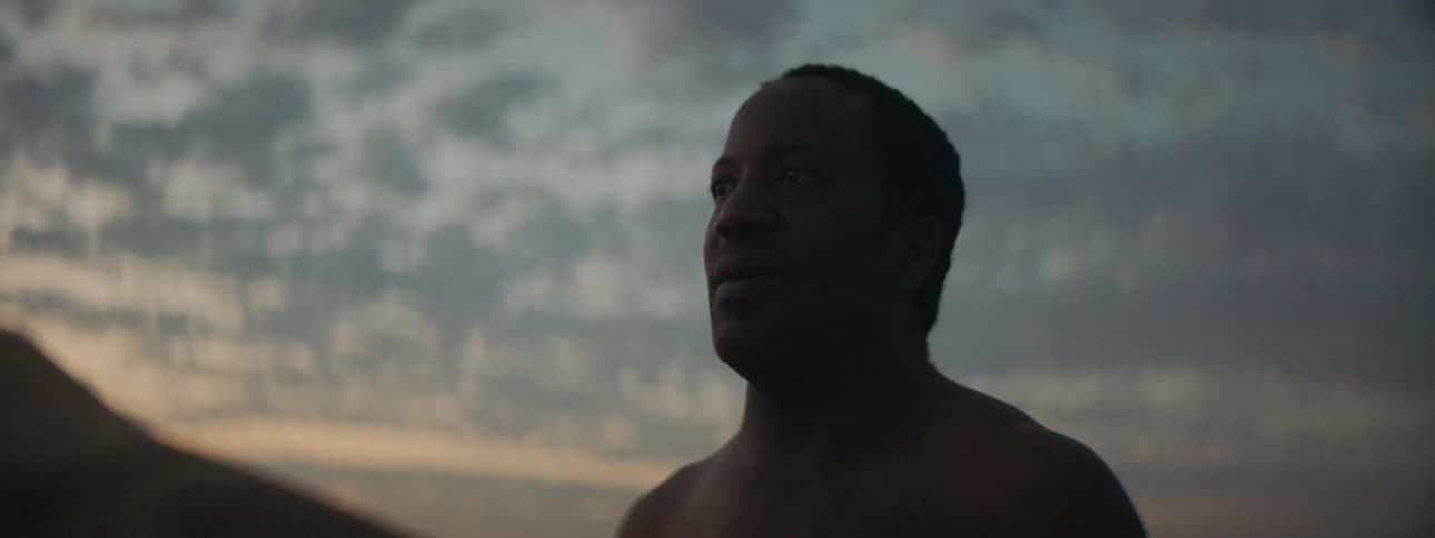 A man standing outside and looking in to the distance