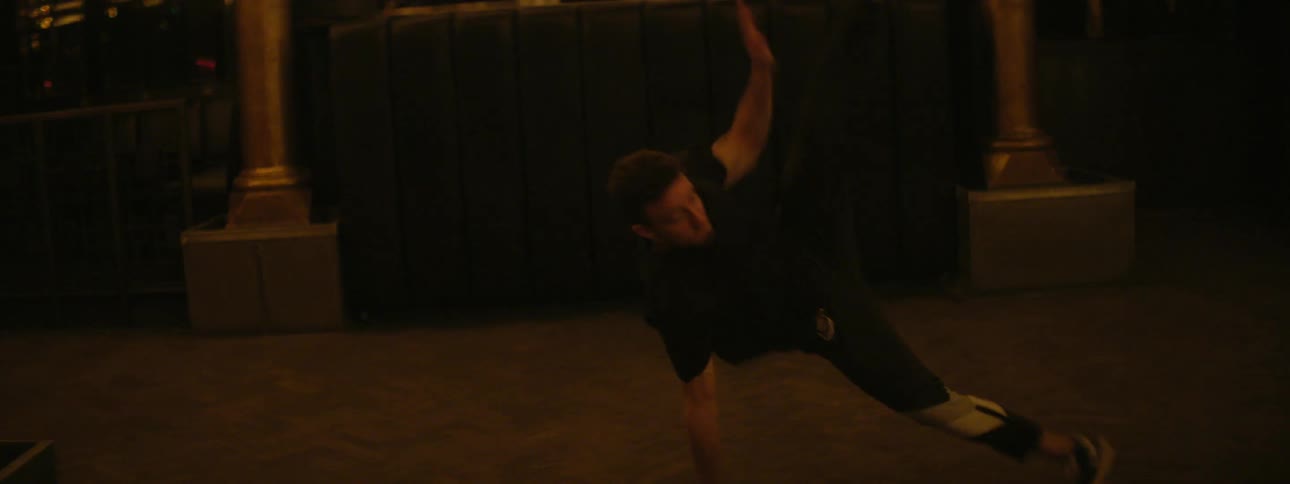 Teenage boys dancing in a building with bright lights
