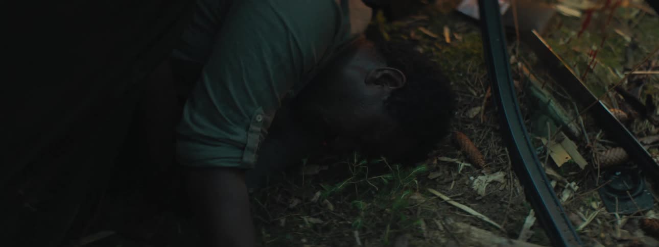 A vehicle crash with a man laying on the ground