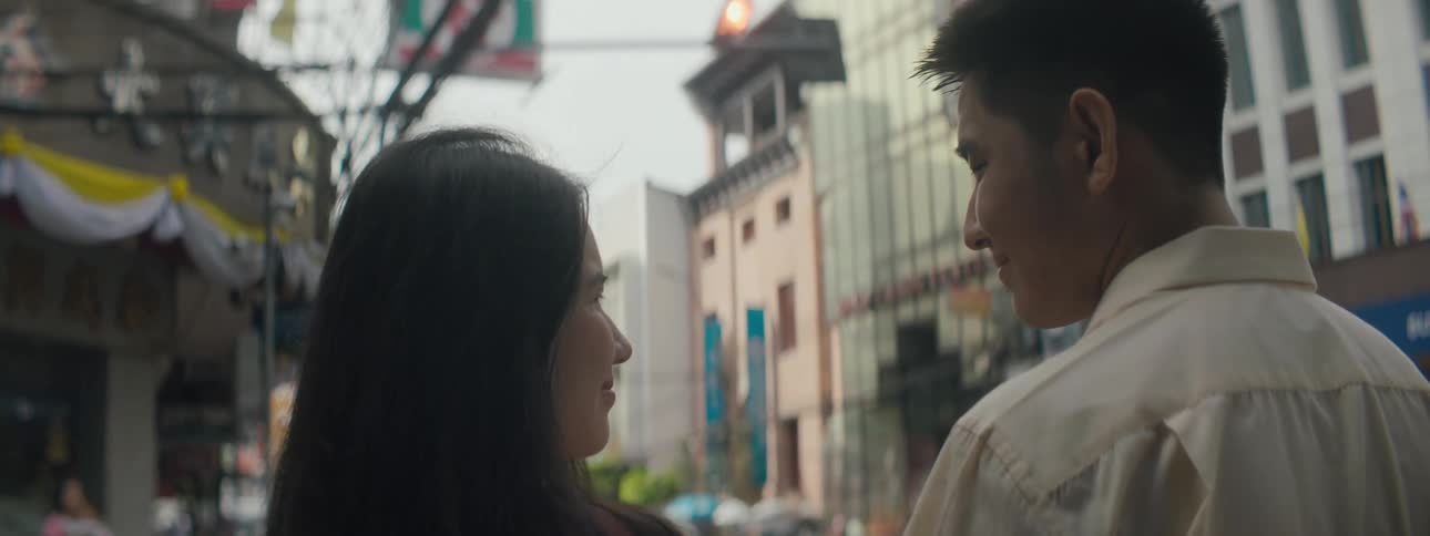 Couple looking at each other in the middle of a city