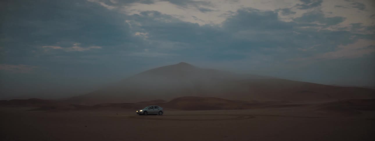 A car spinning cookies on sand in a desert