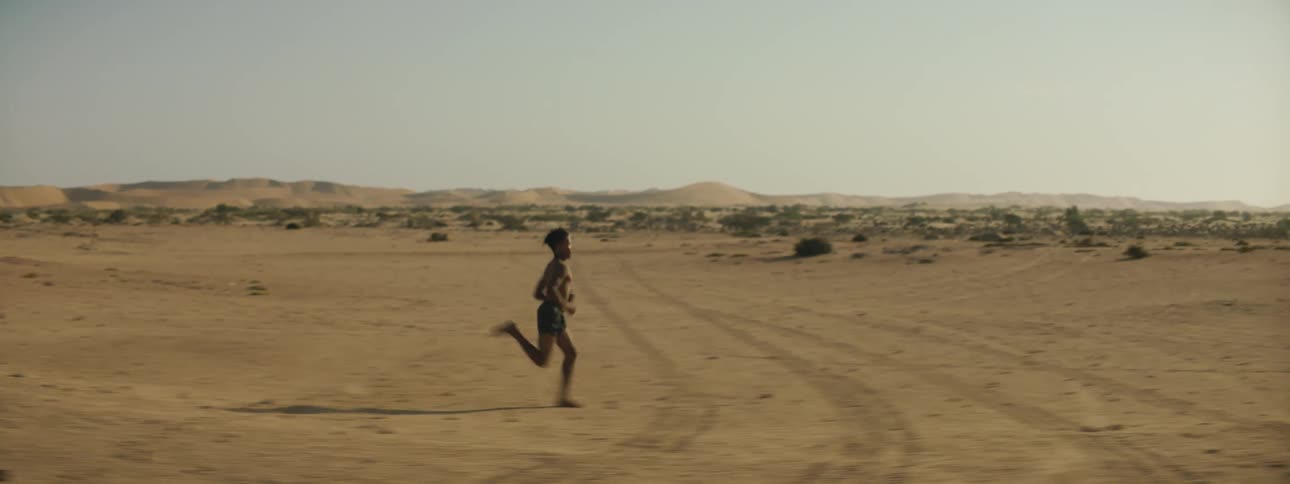A man is jogging outdoors during the day