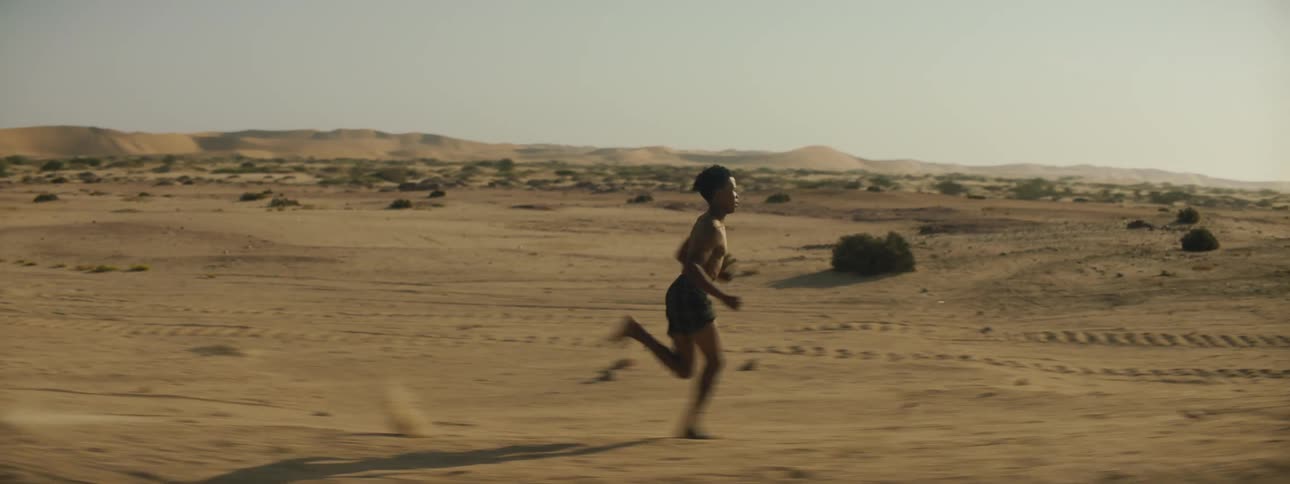 A man is jogging outdoors in the desert