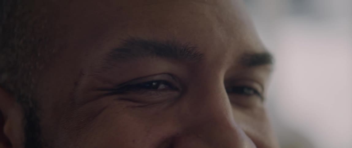 Close up of a mans face as he laughs