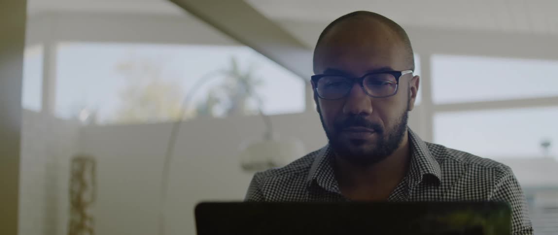 A man is looking at his laptop