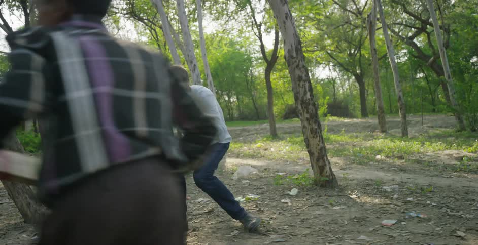 A photographer films two boys playing a game outside