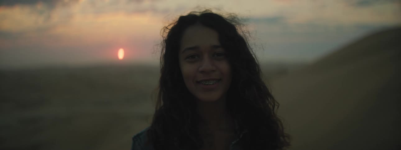 A teenage girl in the desert poses for a photo