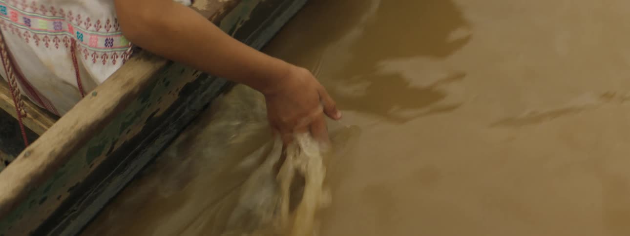 A person dipping their hand in water