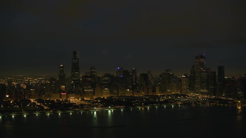 The chicago city skyline lit up and shimmering at night