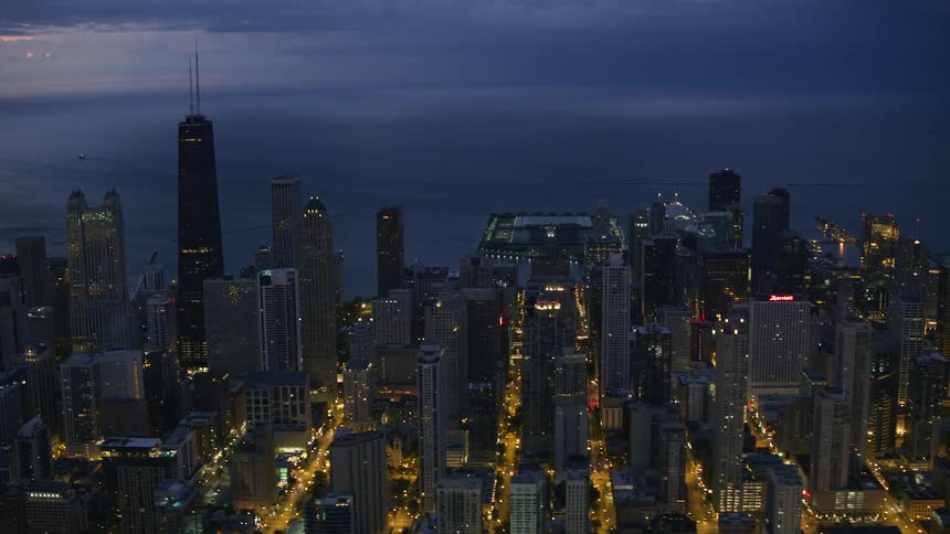 Skyscrapers in a metropolis on the coast under a cloudy sky at sunset