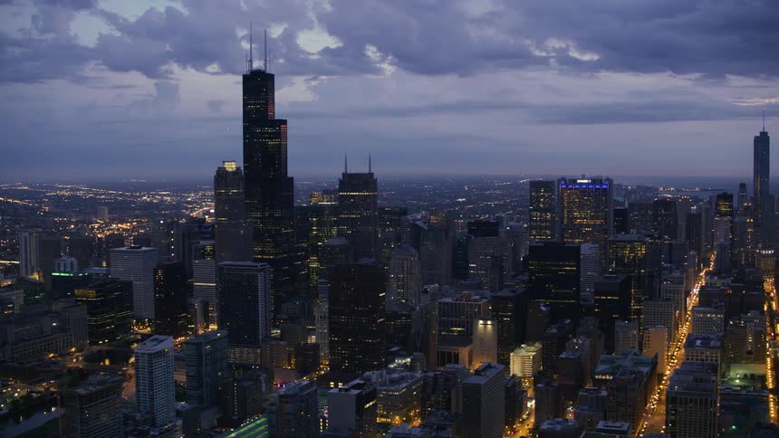 Tall buildings and skyscrapers in a metropolis on a cloudy evening