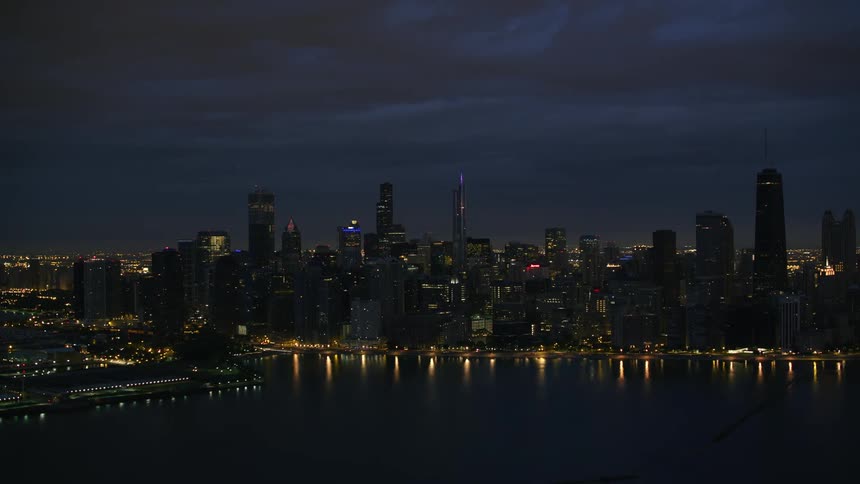 A city along the coast is lit up at night