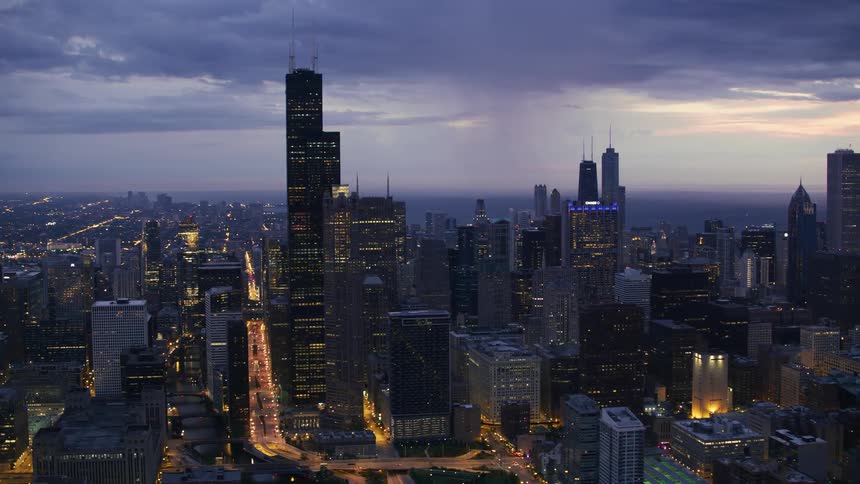 Vehicle headlights light up a city at night