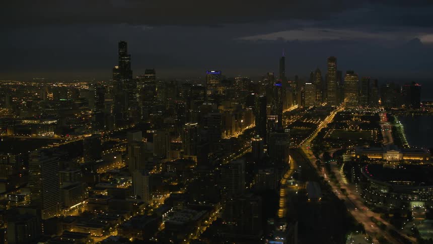 Cars move down the roads of a city at night