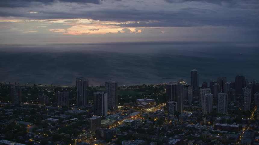 A city is lit up as the sun is setting