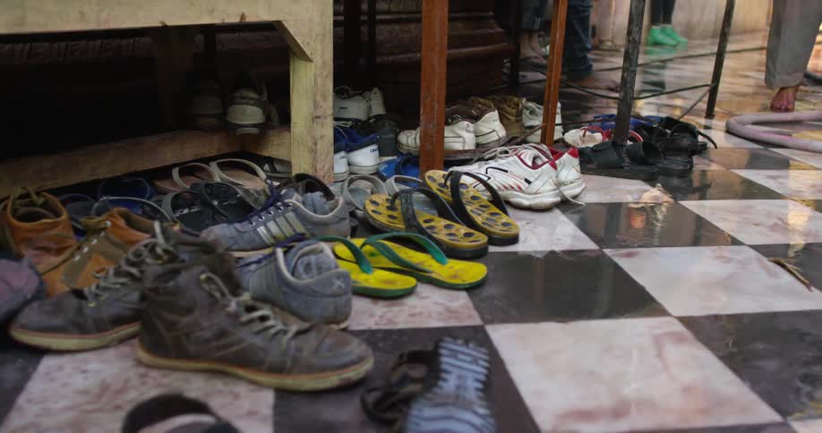 Shoes lined up on a tile floor