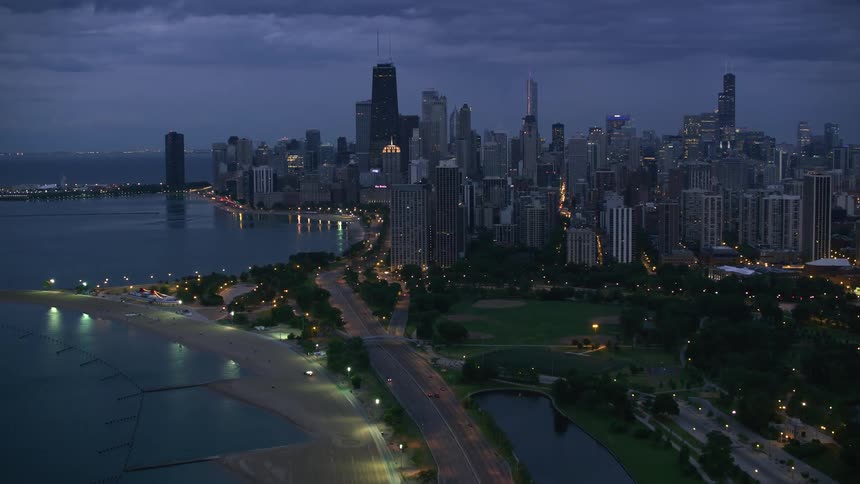 A wide road along the coast of a metropolis on a cloudy night