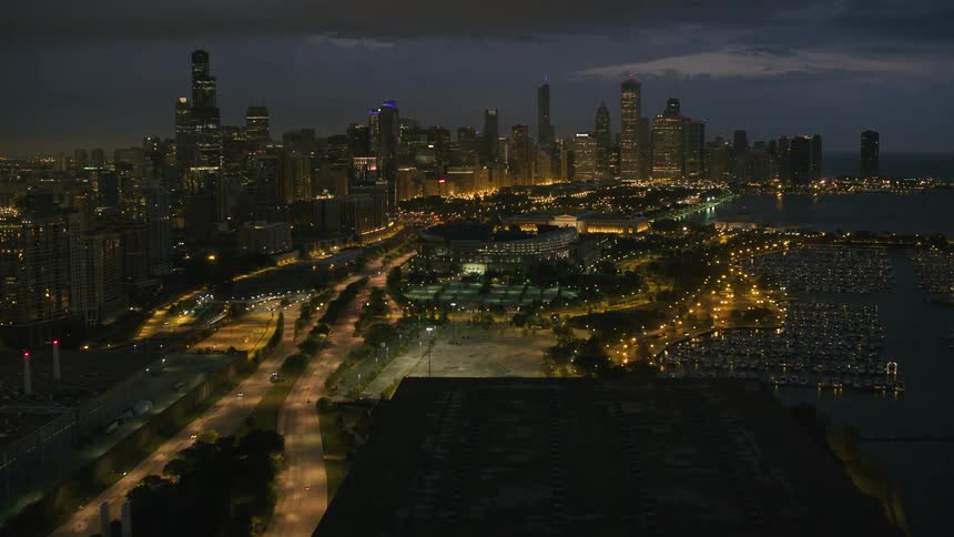 City roads glow brightly in dark downtown of cityscape