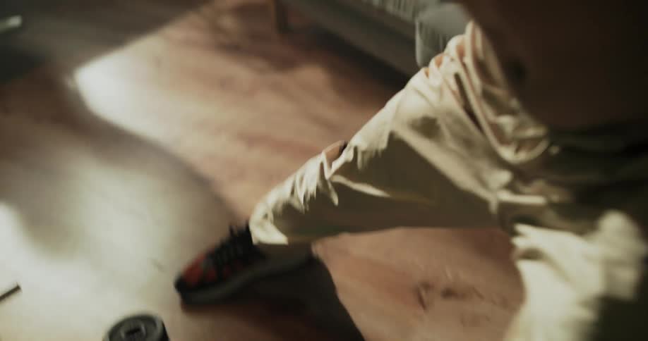 A teenage boy exercises at home