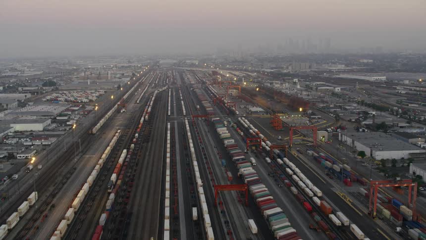 Aerial view of shipping containers loaded on trains on the station at morning