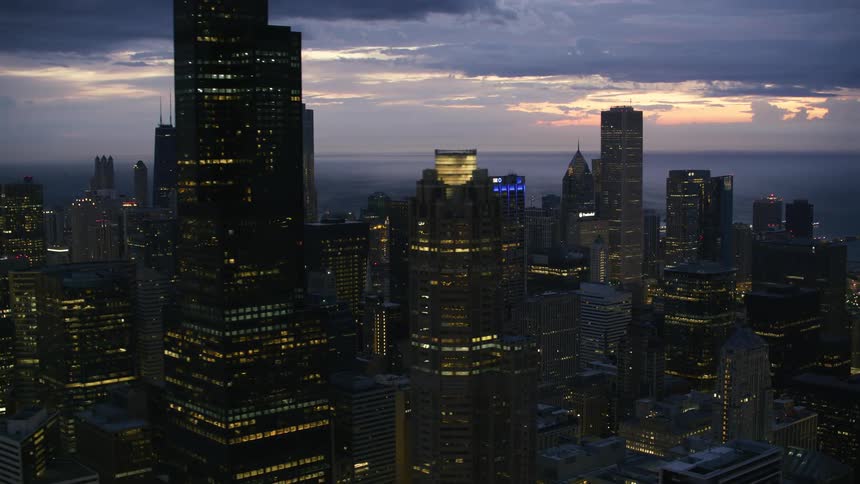 Tall buildings in a metropolis at sunset