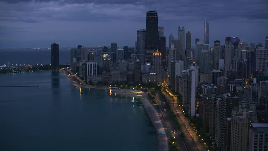 A wide road along the coast of a metropolis on a cloudy night
