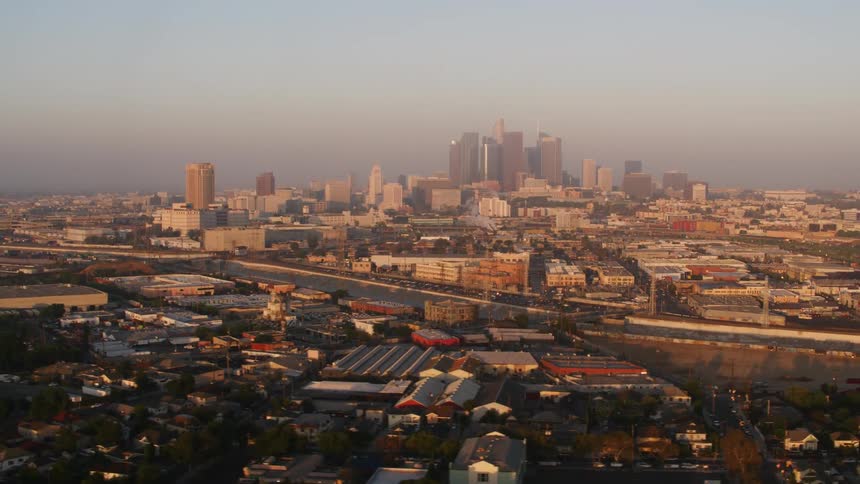 Tall buildings shrouded by smog in a metropolis during the day
