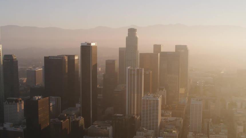 Aerial view of the sunlight shining over skyscrapers on the city skyline at morning
