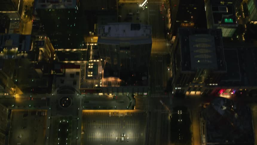 Light traffic flows along city streets at night