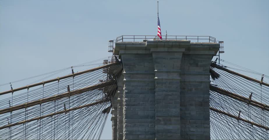 A flag is flying on the top of a bridge