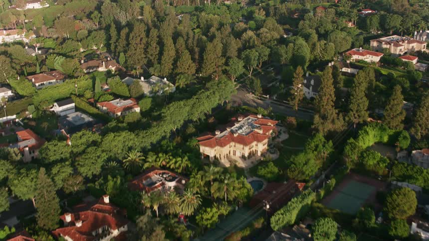 An aerial view of cars and houses in a neighborhood