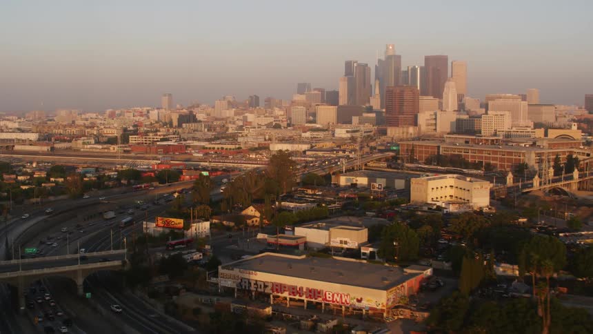 Traffic travels along a freeway through a metropolis in the evening