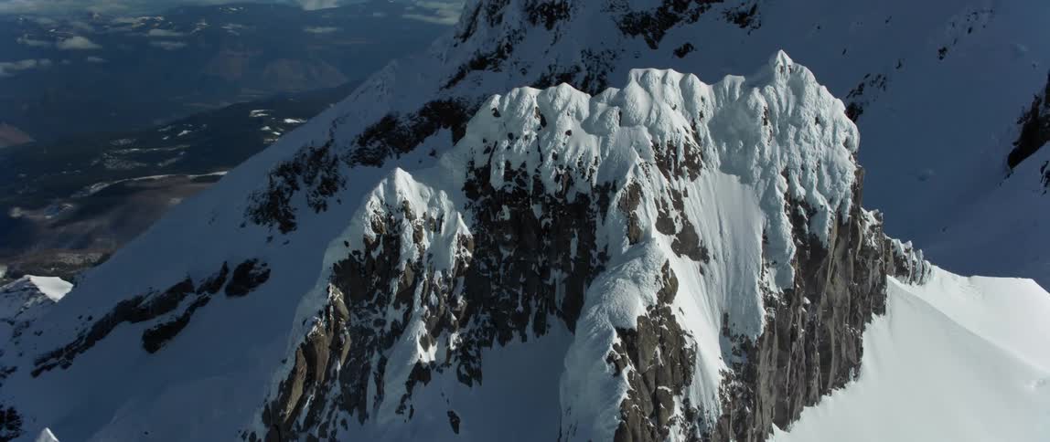An aerial view of a snowy mountain range