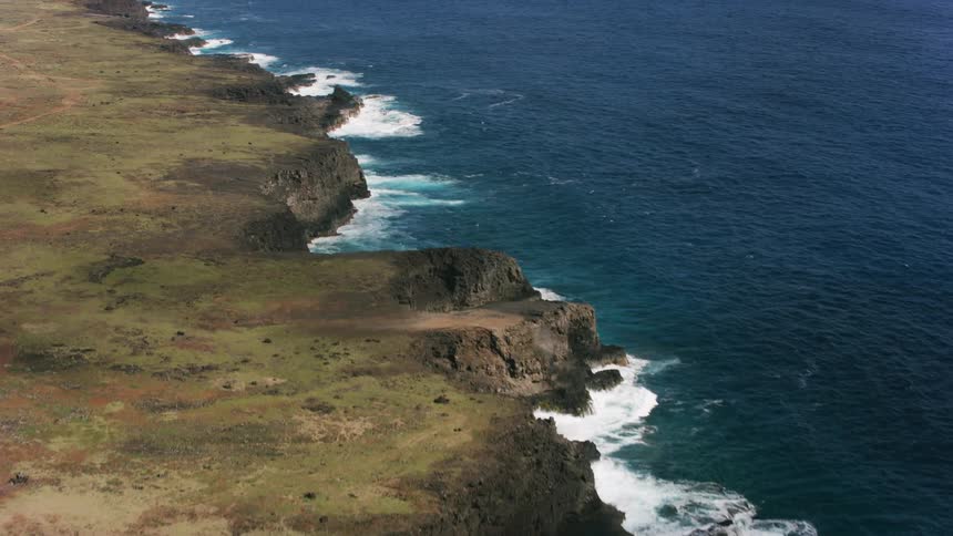 An aerial view of ocean waves rolling in to the shore