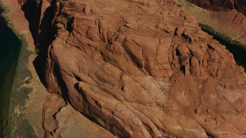 A river running along the floor of an immense canyon during the day