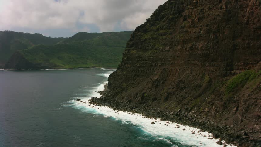 An aerial view of ocean waves meeting the shore