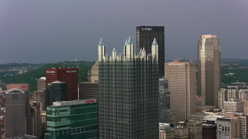An aerial view of high rise office buildings in a downtown area with a river below