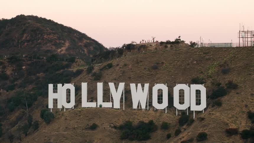 Hollywood sign stands on hill under a red sky