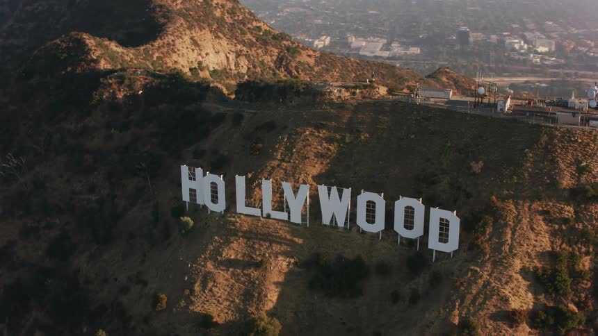 The hollywood sign greets people along a mountain side