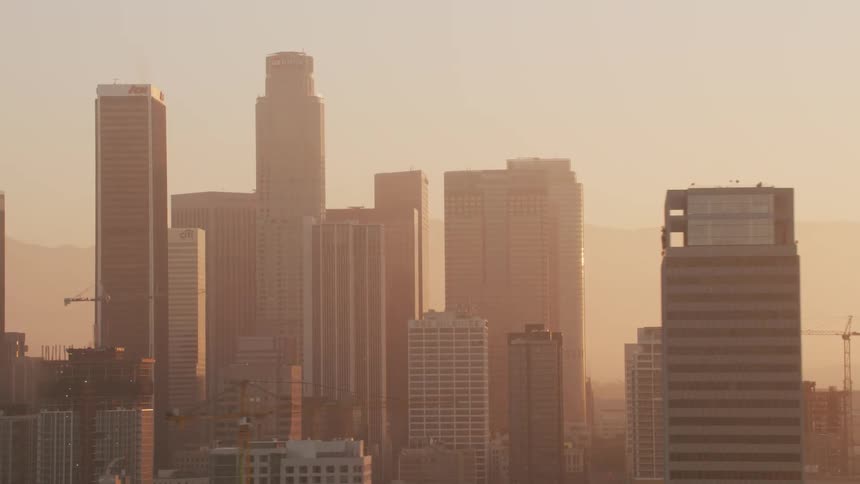Tall buildings in a foggy metropolis during the day